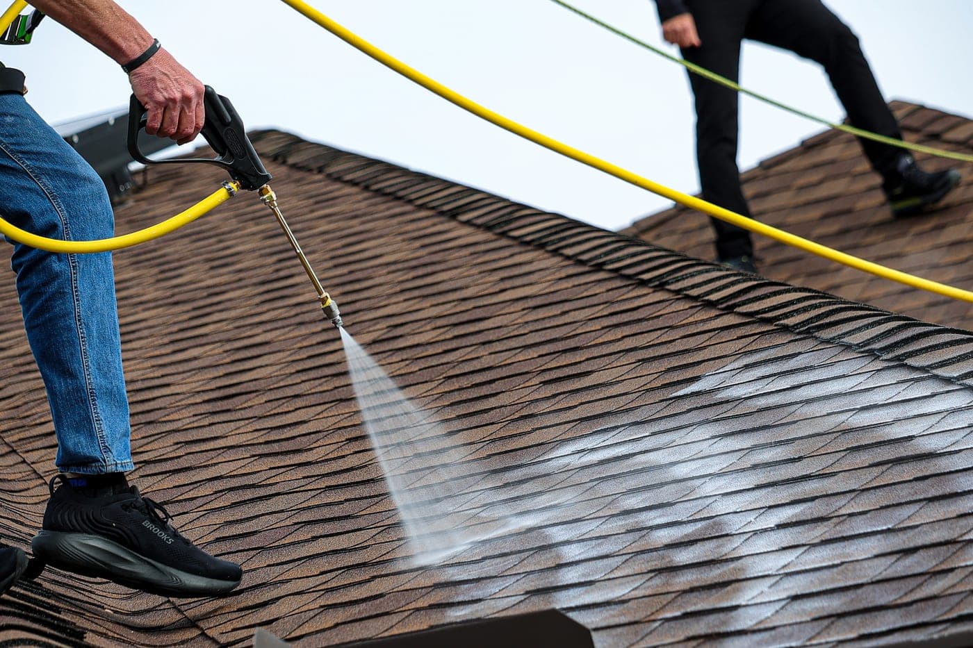 Contractor spraying Shingle Serum on shingles