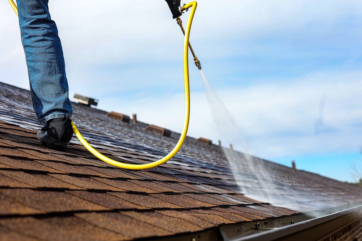 Roofer applying Shingle Serum